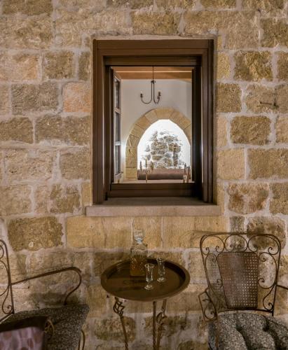 a table and two chairs in front of a mirror at Spanish Knights Inn in Rhodes Town