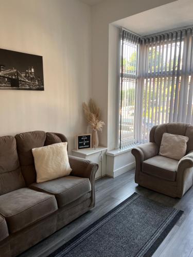 a living room with a couch and a chair at Serene Retreat - Near Bham City Centre & The JQ in Birmingham