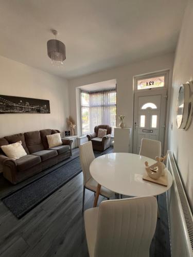 a living room with a white table and chairs at Serene Retreat - Near Bham City Centre & The JQ in Birmingham