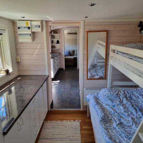 a bedroom with two bunk beds and a mirror at Strandnära boende, Strandbaden in Falkenberg