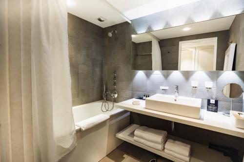 a bathroom with a sink and a tub at Du Côté Des Olivades in Paradou