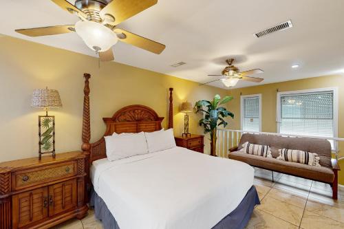 a bedroom with a bed and a ceiling fan at Sailor's Dream in Port Isabel