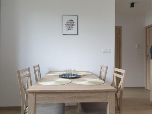 a wooden table with chairs and a dining room at Near the airport- Apartments in Kraków