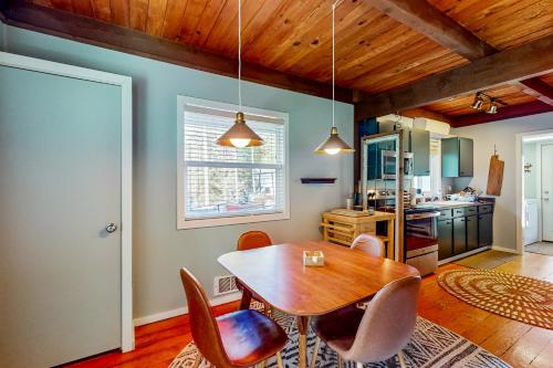 a dining room with a wooden table and chairs at Woodland Wanderlust in Glacier
