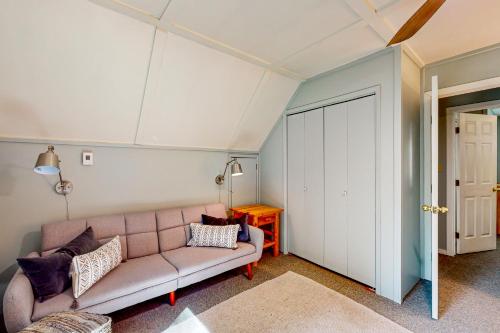 a living room with a couch and a table at Woodland Wanderlust in Glacier