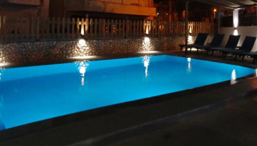 a swimming pool with blue lighting in a building at Hotel Villa Ruci in Ksamil