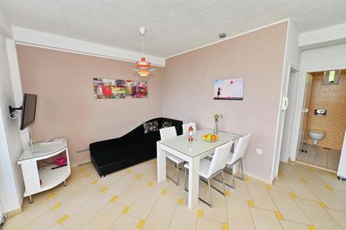 a living room with a white table and a couch at Villa Velestovo in Ohrid