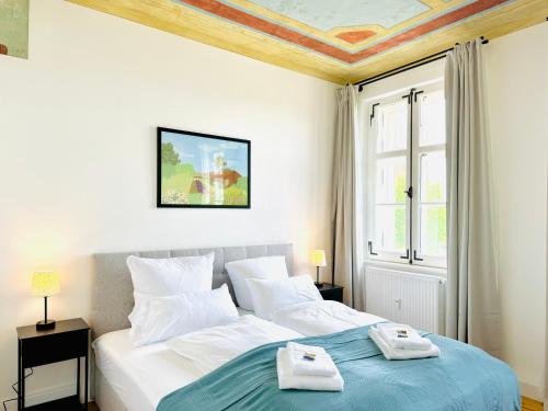 a bedroom with a bed with towels on it at E&K living - design Apartments - SKY-TV - Audi - IN village - free parking in Ingolstadt