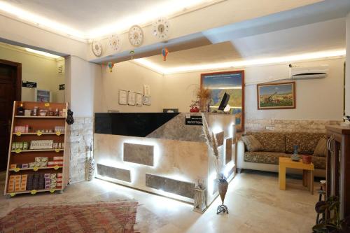 a living room with a couch and a fireplace at OzenTurku Hotel in Pamukkale