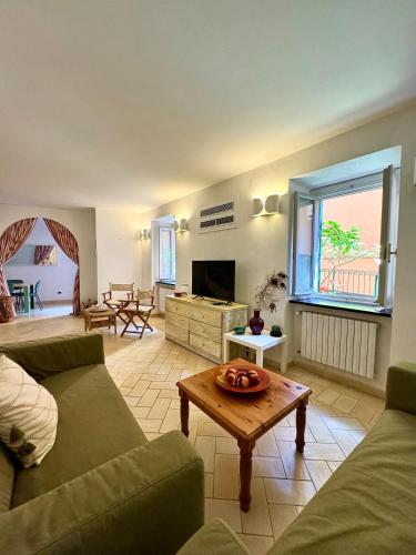 a living room with a couch and a table at Casa • Paraggi • in Paraggi