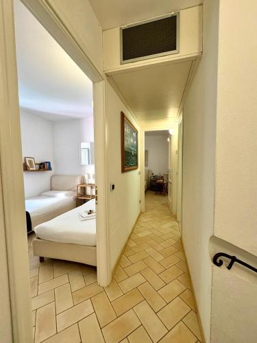 a hallway leading to a room with a bed and a living room at Casa • Paraggi • in Paraggi