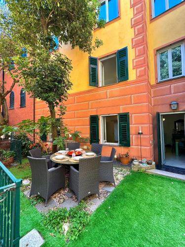 a patio with a table and chairs in front of a building at Casa • Paraggi • in Paraggi