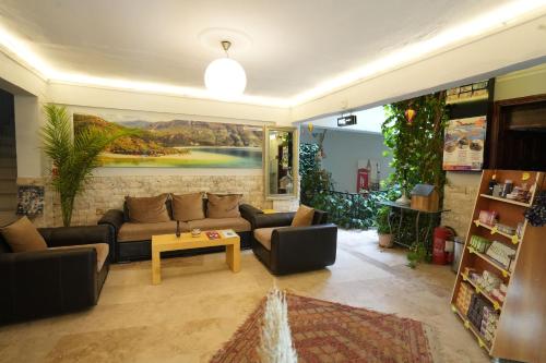 a living room with a couch and a table at OzenTurku Hotel in Pamukkale