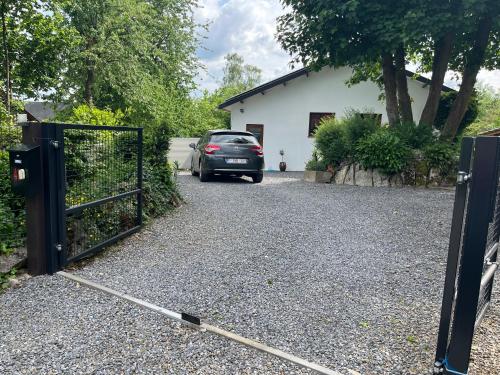 a car parked in front of a driveway with a gate at Studio renové rdc terrasse wépion (Namur) in Namur