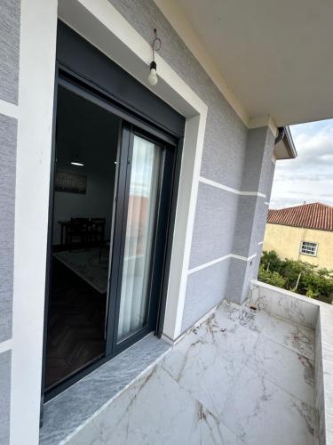 a glass door on the side of a house at Stormi's Apartament in Pogradec