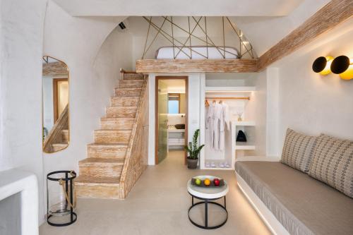 a living room with a staircase and a couch at Athina Luxury Suites in Fira