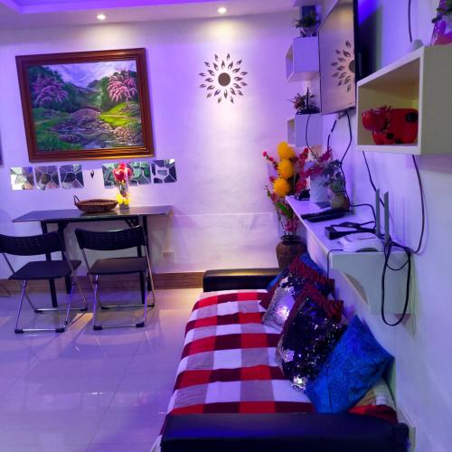 a room with a table and a bed in a room at Cozy Condo Unit w/ FREE WIFI&Netflix-Pay Parking in Antipolo