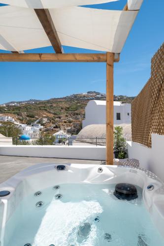 a hot tub on the roof of a house at AngelEve Villa with private Jacuzzi in Fira