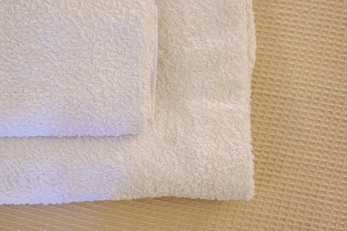 a close up of white towels on a wall at AngelEve Villa with private Jacuzzi in Fira