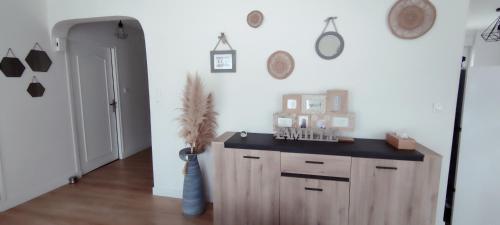 a kitchen with a wooden cabinet in a room at Maison individuelle plein pied in Bray-Dunes