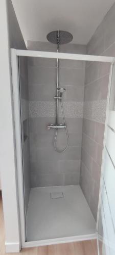 a shower with a glass door in a bathroom at Maison individuelle plein pied in Bray-Dunes