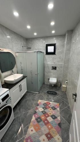 a bathroom with a sink and a toilet in it at Greenplain Smurf in Trabzon