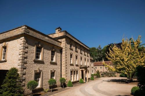 an old stone building with a road in front of it at Easby Hall in Richmond