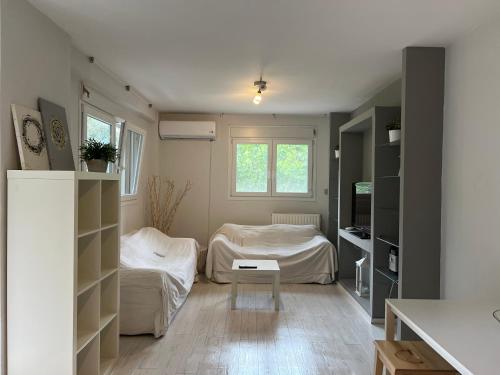 a room with two beds and a table in it at Maria’s apartments in Sparti