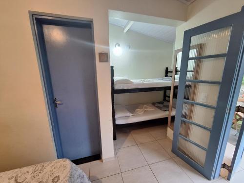 a room with a door leading to a bedroom at Pousada Sobre as Pedras in Itanhaém