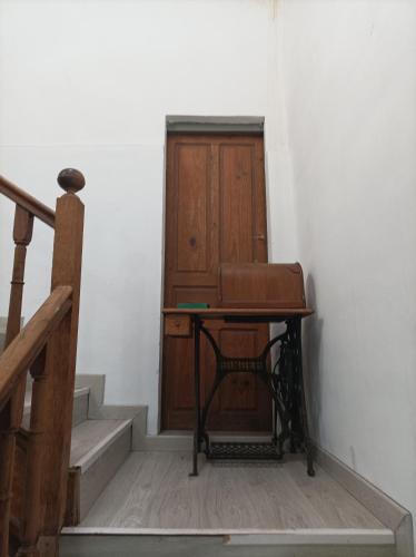 a desk in a room with stairs and a door at La Casona de Ardines in Arenas de Cabrales