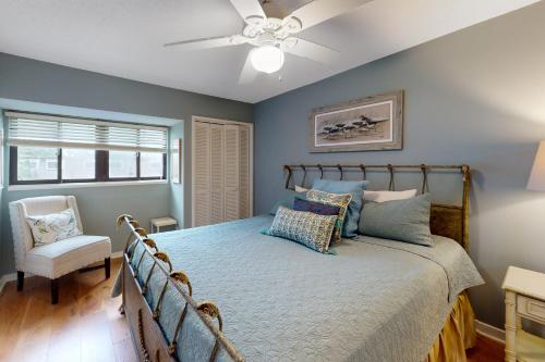 a bedroom with a bed and a ceiling fan at Harbour Town Club Villas 1253 in Hilton Head Island