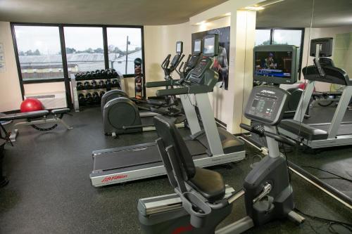 a gym with treadmills and elliptical machines at Holiday Inn New Orleans West Bank Tower by IHG in Gretna