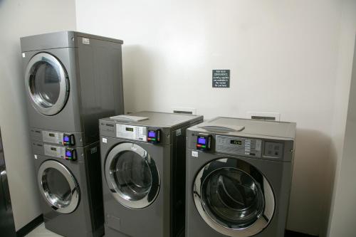 three washing machines and a washer and dryer in a room at Holiday Inn New Orleans West Bank Tower by IHG in Gretna