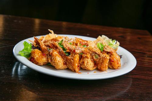 a plate of food with chicken on a table at Holiday Inn New Orleans West Bank Tower by IHG in Gretna