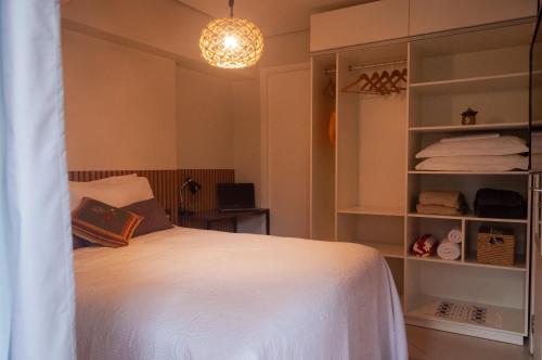 a bedroom with a white bed and a book at LANDSCAPE SOLAR - Beira Mar de Fortaleza in Fortaleza
