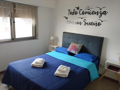 a bedroom with two beds with towels on them at Las diagonales in La Plata