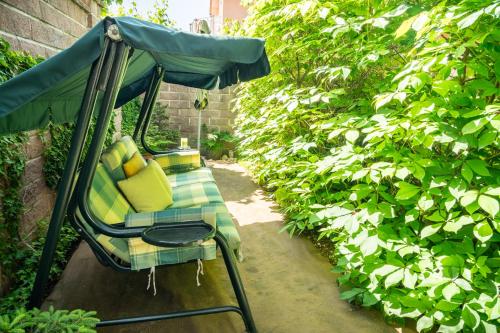 a gazebo with a chair in a garden at Residence Moritz with Sauna in Mozirje