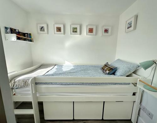a small bedroom with a bed in a room at Sea Walk Cottage, Milford On Sea in Milford on Sea
