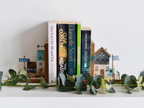 a row of books sitting on a shelf at Mary Bowes Terrace in Bournemouth