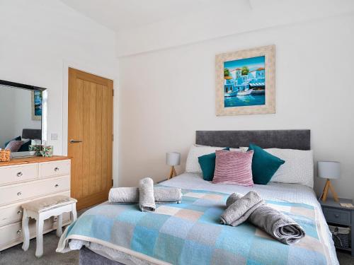 a bedroom with a bed with towels on it at Mary Bowes Terrace in Bournemouth