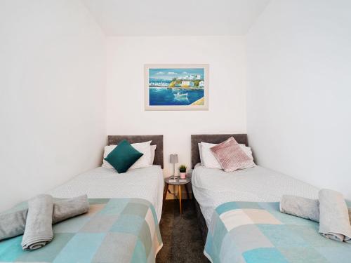 Pokój z 2 łóżkami pojedynczymi i stołem w obiekcie Mary Bowes Terrace w Bournemouth