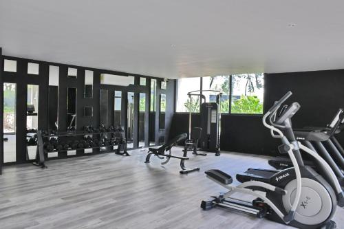 a gym with several exercise equipment in a room at IIK Tulum Luxury Condo by Spot Rentals in Tulum