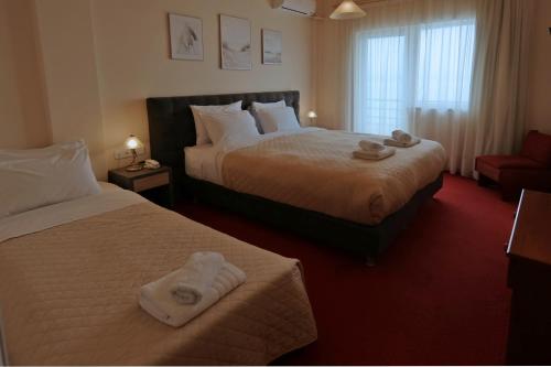 Ένα ή περισσότερα κρεβάτια σε δωμάτιο στο Hotel Excelsior