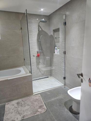 a bathroom with a shower and a toilet and a sink at Premium farmhouse with pool in Rabat