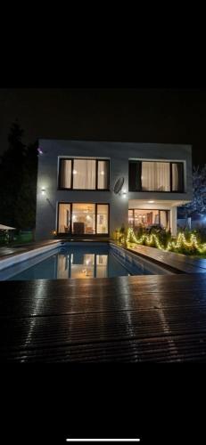 a large house with a swimming pool at night at La bella vue in Osenjače