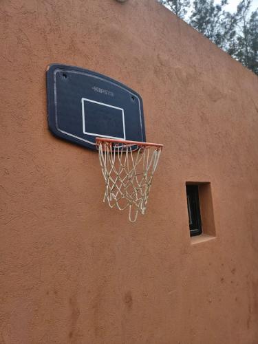 a basketball hoop on the side of a building at Premium farmhouse with pool in Rabat
