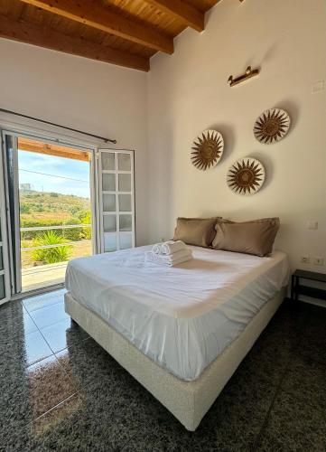 a bedroom with a bed and two mirrors on the wall at Felicity Seaside Retreat in Ermioni