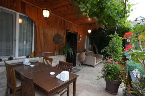 a patio with a table and chairs and a couch at OzenTurku Hotel in Pamukkale