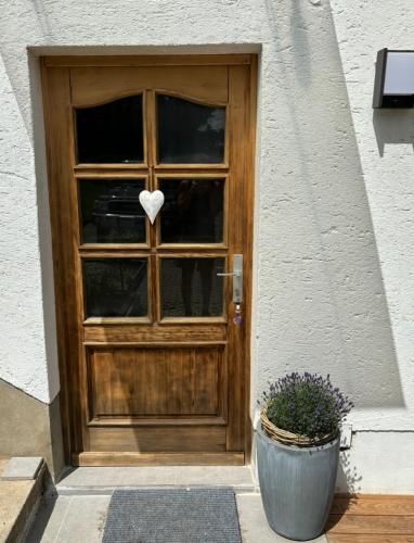 a wooden door with a heart in the window at Carinthia Freedom Lodge in Töschling