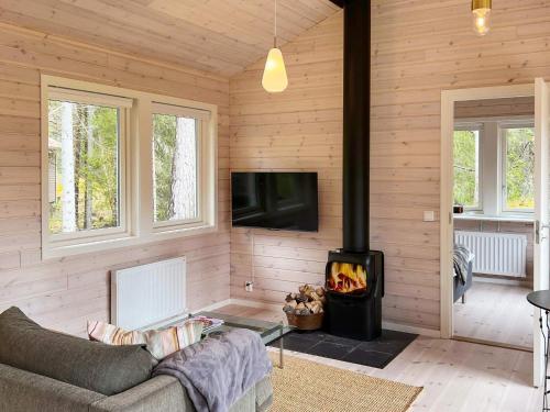 a living room with a couch and a fireplace at 4 star holiday home in VäTö in Vätö